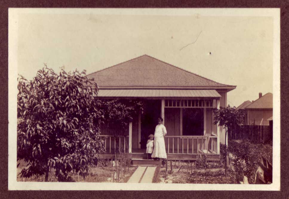 Jesús (García) Alvarado (1871-1966) with daughter outside the family home at 717 Bailey Street in Los Angeles